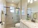 Bathroom with tile shower, glass door, granite countertop, and bronze fixtures at 5810 Brandon Run, Bradenton, FL 34211