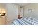 Cozy bedroom offers a comfortable bed, a large closet, and dresser with lighting at 5810 Brandon Run, Bradenton, FL 34211