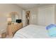 Comfortable bedroom features a striped bedspread, light wood dresser, and double door closet at 5810 Brandon Run, Bradenton, FL 34211