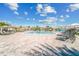 Expansive community pool area with lounge chairs and a rock waterfall feature for relaxation and enjoyment at 5810 Brandon Run, Bradenton, FL 34211