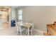 Bright dining area features a four-chair table with beach-themed decor and nearby kitchen at 5810 Brandon Run, Bradenton, FL 34211