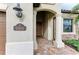 Inviting front porch with elegant pillars and stone accents, leading to a warm wooden door at 5810 Brandon Run, Bradenton, FL 34211