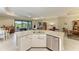 Open kitchen boasts a granite countertop island and stainless steel appliances, great for entertaining at 5810 Brandon Run, Bradenton, FL 34211