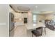 Spacious kitchen boasts stainless steel appliances, granite counters, and white cabinets with an adjacent living area at 5810 Brandon Run, Bradenton, FL 34211