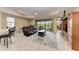 Spacious living room with neutral tones, a ceiling fan, and a sliding glass door to the outdoor living space at 5810 Brandon Run, Bradenton, FL 34211