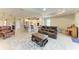 Expansive living area showcases tile flooring, an open layout, and easy access to the kitchen and dining spaces at 5810 Brandon Run, Bradenton, FL 34211