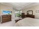 Well-lit main bedroom has neutral walls, carpet, and access to the patio and main bathroom at 5810 Brandon Run, Bradenton, FL 34211