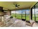 Outdoor kitchen features stone accents, a stainless steel grill, and stunning golf course views at 5810 Brandon Run, Bradenton, FL 34211