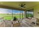 Relaxing screened patio offers beautiful golf course views and comfortable outdoor seating with dining table at 5810 Brandon Run, Bradenton, FL 34211