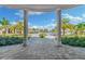 Pristine pool area framed by columns with a clear view of palm trees, loungers, and sparkling water at 5810 Brandon Run, Bradenton, FL 34211