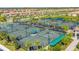 Active tennis courts surrounded by lush landscaping, palm trees and community homes in the background at 5810 Brandon Run, Bradenton, FL 34211