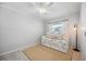 Bedroom showcasing trundle bed, beige rug, white walls, and a ceiling fan with a light fixture at 5912 Driftwood Ave # 22, Sarasota, FL 34231