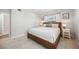 Cozy bedroom with neutral tones, tiled floors, comfortable bed, and decorative nightstands at 5912 Driftwood Ave # 22, Sarasota, FL 34231