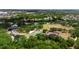 Community aerial view showcasing a pond, sports courts, and lush green trees at 6418 Rosefinch Ct # 103, Lakewood Ranch, FL 34202