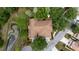 Aerial view of a home with a brown roof, lush landscaping, and a nearby pond at 6418 Rosefinch Ct # 103, Lakewood Ranch, FL 34202