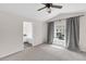 Large bedroom featuring a view into the ensuite bath, neutral walls and carpeted floors at 6418 Rosefinch Ct # 103, Lakewood Ranch, FL 34202