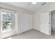Cozy bedroom featuring natural light from a large window and a closet with double doors at 6418 Rosefinch Ct # 103, Lakewood Ranch, FL 34202