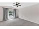 Spacious empty bedroom with neutral carpeting, ceiling fan, and a bright window with curtains at 6418 Rosefinch Ct # 103, Lakewood Ranch, FL 34202