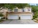 Exterior view of a home featuring an attached two-car garage and manicured landscaping at 6418 Rosefinch Ct # 103, Lakewood Ranch, FL 34202