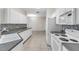Kitchen featuring white cabinets, tile backsplash, stainless steel sink and appliances at 6418 Rosefinch Ct # 103, Lakewood Ranch, FL 34202