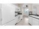 Bright kitchen with white appliances, tile backsplash, and ample cabinet space at 6418 Rosefinch Ct # 103, Lakewood Ranch, FL 34202