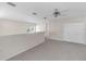 Open loft area with neutral walls, plush carpeting, and a ceiling fan for added comfort at 6418 Rosefinch Ct # 103, Lakewood Ranch, FL 34202