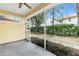 Enclosed patio with view of backyard and mature trees at 6418 Rosefinch Ct # 103, Lakewood Ranch, FL 34202