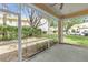 Enclosed patio with view of backyard, mature trees and parking area at 6418 Rosefinch Ct # 103, Lakewood Ranch, FL 34202