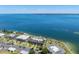 Waterfront condominium complex featuring lush landscaping and a tranquil coastal setting at 6500 Flotilla Dr # 126, Holmes Beach, FL 34217