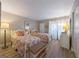 Light-filled bedroom with twin beds, soft lighting, and closet space at 6500 Flotilla Dr # 126, Holmes Beach, FL 34217