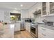 Beautiful kitchen featuring white cabinets, stainless steel appliances, and stone countertops at 6500 Flotilla Dr # 126, Holmes Beach, FL 34217