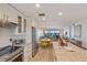Open kitchen with stainless appliances and breakfast bar overlooking the living and dining areas at 6500 Flotilla Dr # 126, Holmes Beach, FL 34217