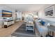 Cozy living room features beach-themed decorations, wood-look flooring, and flows into the kitchen for easy living at 6500 Flotilla Dr # 126, Holmes Beach, FL 34217