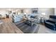 Bright living room features beachy decor, wood-look flooring, comfortable seating, and an open floorplan at 6500 Flotilla Dr # 126, Holmes Beach, FL 34217