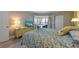 Comfortable main bedroom with french doors to the lanai, neutral decor, and soft lighting at 6500 Flotilla Dr # 126, Holmes Beach, FL 34217