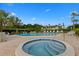 Community offers a luxurious pool and hot tub area surrounded by comfortable lounge chairs and tropical landscaping at 6500 Flotilla Dr # 126, Holmes Beach, FL 34217