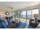 Relaxing sun room with expansive windows offering water views, comfortable seating, and tranquil space at 6500 Flotilla Dr # 126, Holmes Beach, FL 34217