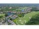 Stunning aerial view of property on a golf course with lush landscaping and serene lake views at 6642 Oakland Hills Dr, Lakewood Ranch, FL 34202