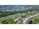 Stunning aerial view showcases lush landscaping, golf course, serene lake and surrounding homes in gated community at 6642 Oakland Hills Dr, Lakewood Ranch, FL 34202