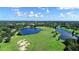 Expansive aerial view of a golf course community with lakes, lush greenery, and a clear blue sky at 6642 Oakland Hills Dr, Lakewood Ranch, FL 34202