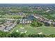 Aerial view of a home and surrounding community, golf course, lakes, and verdant landscape at 6642 Oakland Hills Dr, Lakewood Ranch, FL 34202