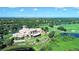 Expansive aerial showcasing a beautiful community clubhouse overlooking lush greenery and the golf course at 6642 Oakland Hills Dr, Lakewood Ranch, FL 34202