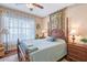 Comfortable bedroom featuring a four-poster bed and decorative wallpaper border at 6642 Oakland Hills Dr, Lakewood Ranch, FL 34202