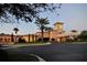 Elegant clubhouse exterior at twilight, featuring lush landscaping and manicured lawns at 6642 Oakland Hills Dr, Lakewood Ranch, FL 34202