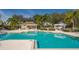 Community pool area with a covered pavilion, lounge chairs, and immaculately kept landscaping at 6642 Oakland Hills Dr, Lakewood Ranch, FL 34202