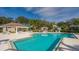 Community pool featuring ample seating, lush landscaping, and a covered pavilion at 6642 Oakland Hills Dr, Lakewood Ranch, FL 34202