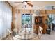 Bright breakfast nook with a glass table and views of the backyard with a sliding door and stylish furnishings at 6642 Oakland Hills Dr, Lakewood Ranch, FL 34202