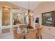 Dining room showcases custom display shelves, a glass table, and stylish chairs at 6642 Oakland Hills Dr, Lakewood Ranch, FL 34202