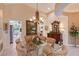 Well-lit dining room with a glass table, chandelier, and neutral paint colors at 6642 Oakland Hills Dr, Lakewood Ranch, FL 34202
