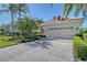 Exterior with stone driveway and mature landscaping at 6642 Oakland Hills Dr, Lakewood Ranch, FL 34202